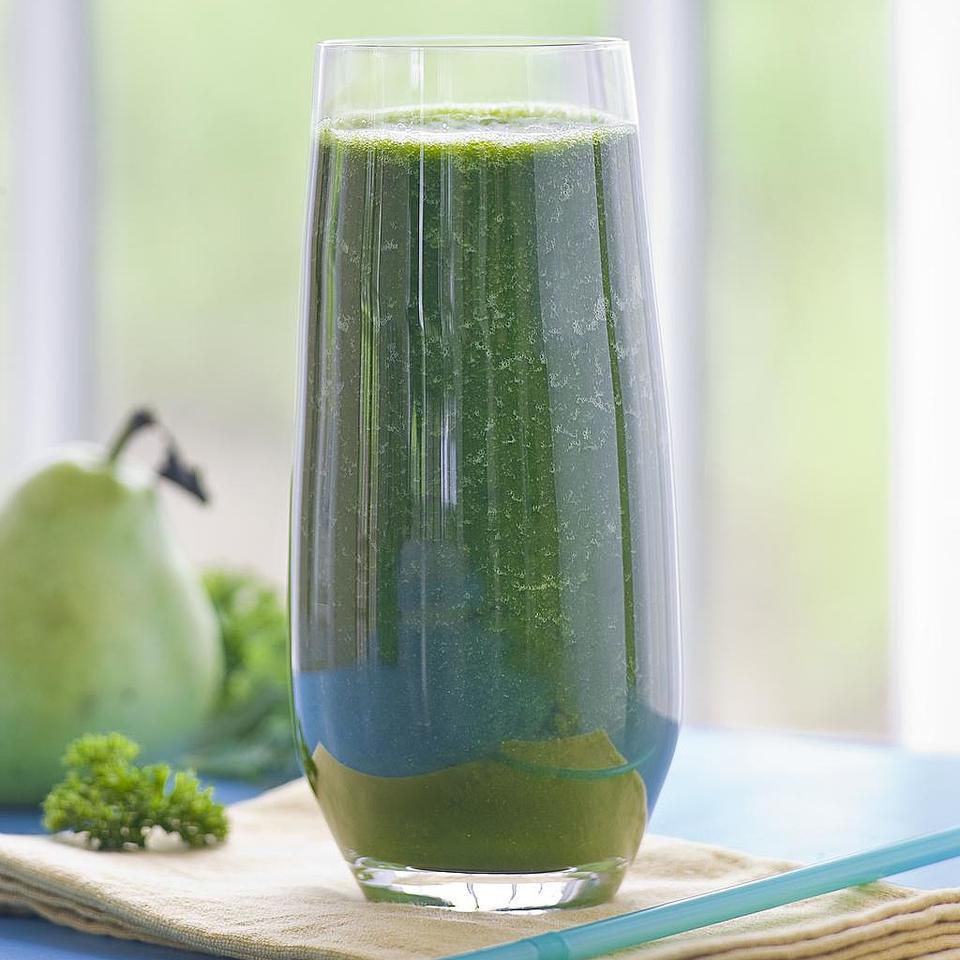A glass of a green cola.