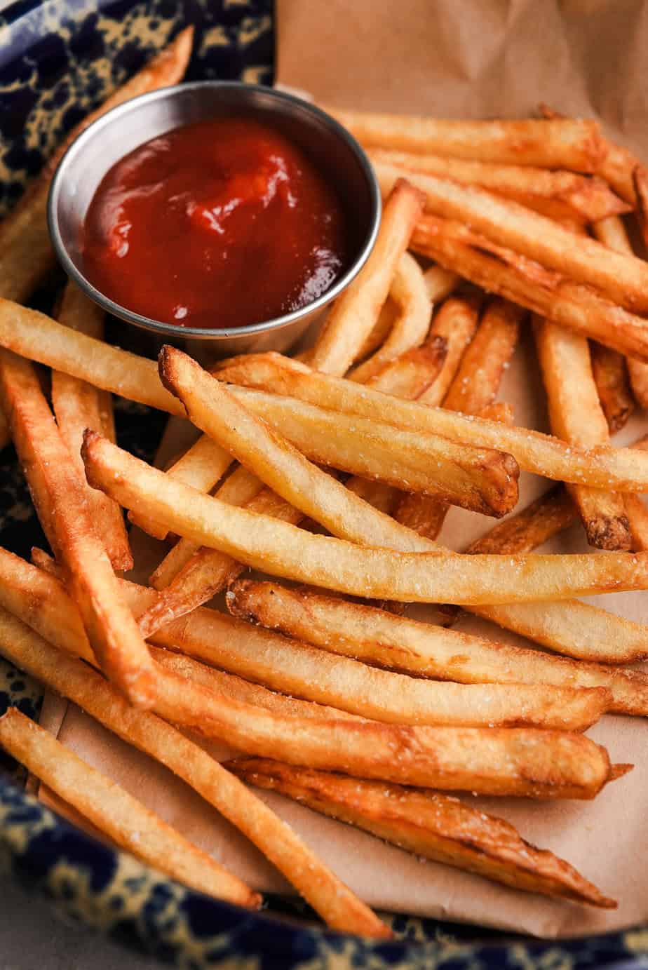 Picture of French fries with ketchup in a small bowl next to them.