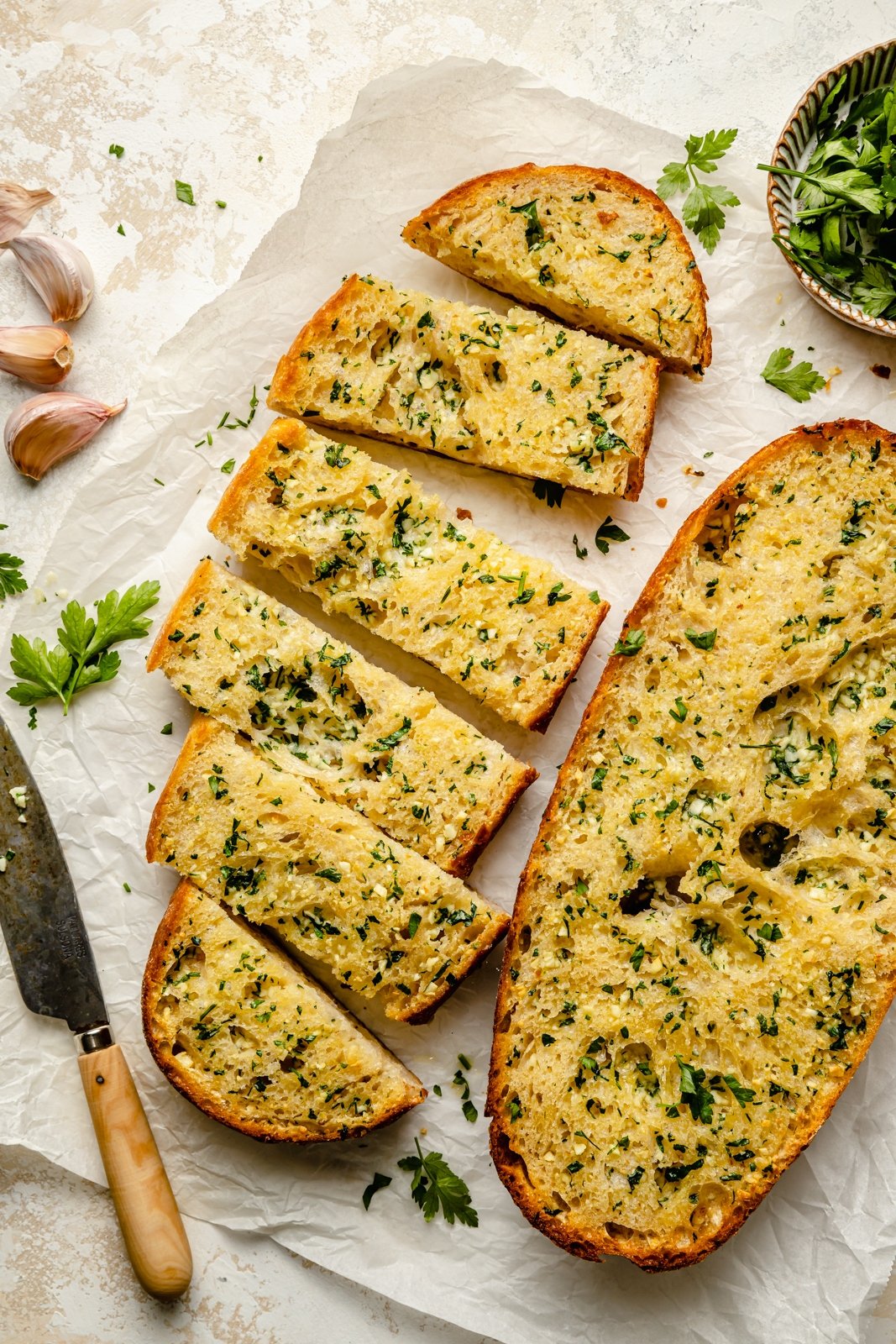 An image of 2 slices of garlic bread, one cut up.